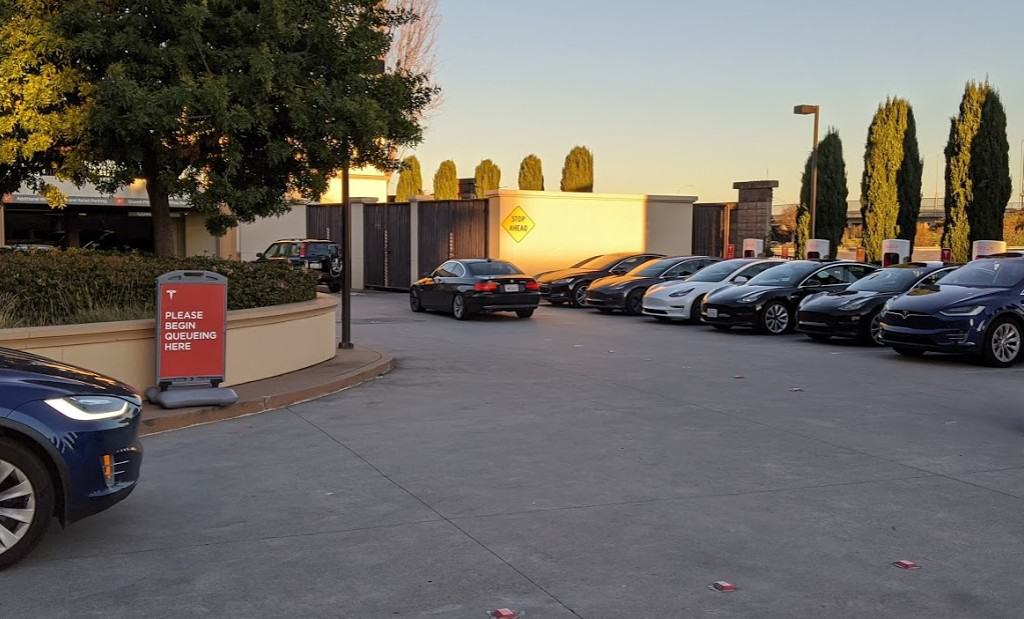 Tesla Supercharger Queue Line with Sign